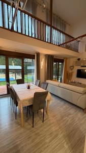 a living room with a table and chairs and a couch at VILLA TOMILLARES in Los Tomillares