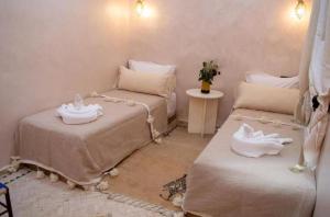 a room with two beds with white shoes on them at Villa Dar Saada in Marrakesh
