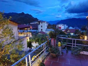 a view from the balcony of a house at night at Beautiful Homestay Sapa in Sapa