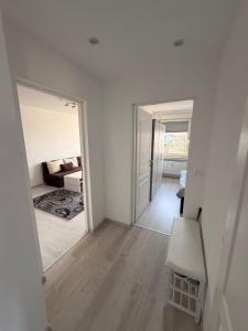 a white room with a mirror and a couch at Kleines Appartment mit großer Terrasse in Herscheid