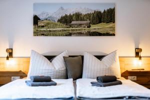 a bedroom with two beds and a painting on the wall at Haus Tisch in Schruns