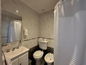 a bathroom with a shower and a toilet and a sink at Hotel Hijos Del Mar - Rincón Costero in Miramar