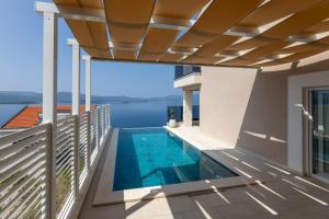 a view from the balcony of a house with a swimming pool at Villa Sole in Komarna