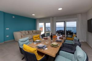 a living room with a wooden table and chairs at Villa Sole in Komarna