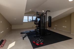 a fitness room with a gym with red shoes at Villa Sole in Komarna