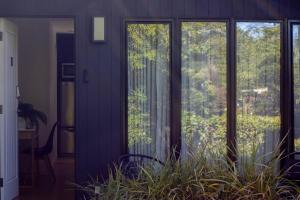 a room with sliding glass doors with a plant at Lakes Edge 1 - 2BR Close to Lake in Wendouree