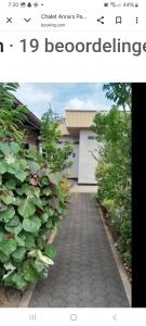 a screenshot of a picture of a walkway in front of a building at Chalet Anna's Pavalesto in Landsboerderij