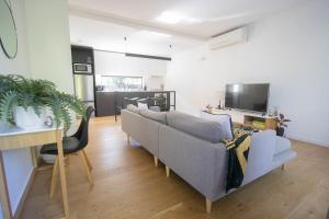 a living room with a couch and a tv at Lakes Edge 1 - 2BR Close to Lake in Wendouree