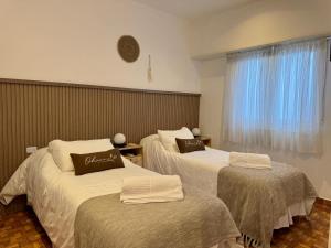 a hotel room with two beds and a window at Hotel Hijos Del Mar - Rincón Costero in Miramar