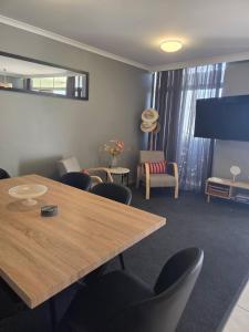 a conference room with a wooden table and chairs at Yarrawonga Lakeside Apartment 31 in Mulwala