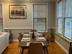 a dining room with a table and chairs and a couch at 25 Lux Room 3 - 1 Queen Bed, Shared Bathroom - Nonsmoking in Arlington +5 photos