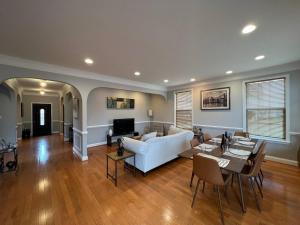 a living room with a white couch and a table at 25 Lux Room 2 - 1 Queen Bed, Shared Bathroom - Nonsmoking in Arlington