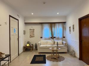 a living room with a couch and a table at Hotel Hijos Del Mar - Rincón Costero in Miramar