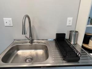 a kitchen counter with a sink and a stove at 25 Lux Room 5 - 2 Queen Beds, Shared Bathroom - Nonsmoking in Arlington +7 photos