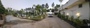a truck parked in a driveway next to a building at Ambience Retreat in Malavalli +3 photos