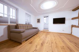 a living room with a couch and a flat screen tv at Modernes Altstadt-Juwel in Buchen