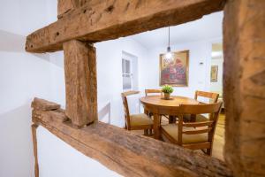 a dining room with a wooden table and chairs at Modernes Altstadt-Juwel in Buchen