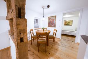 a dining room with a wooden table and chairs at Modernes Altstadt-Juwel in Buchen +7 photos