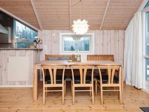 a dining room with a wooden table and chairs at 6 person holiday home in Toftlund-By Traum in Toftlund