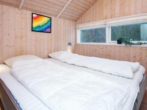 a large white bed in a room with a window at 6 person holiday home in Toftlund-By Traum in Toftlund