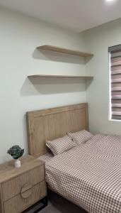 a bedroom with two beds and a vase on a table at Niu Homestay in An Khê