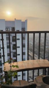 a table on a balcony with a view of a city at Niu Homestay in An Khê