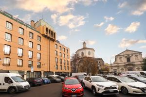 a bunch of cars parked in a parking lot at Duomo Luxury Apartment XI in Milan