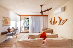 a bedroom with a bed and a table and chairs at Los Arrecifes in Tulum