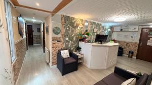 an office with a reception desk and a chair at Verdemar Rooms in Gijón