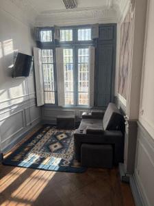 a living room with a couch and some windows at hostel family in Santiago