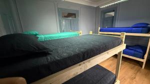 a bedroom with two bunk beds and blue chairs at hostel family in Santiago