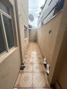a hallway with a tiled floor in a building at Casa BIG John 3 mato grosso in Divinópolis +13 photos