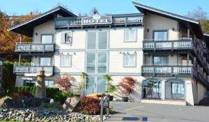a hotel with a sign on the front of it at Heron's Landing Hotel in Campbell River