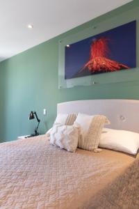 a bedroom with a large bed with a tv on the wall at Studio Apartment Zona 10 near airport in Estación Pamplona +9 photos