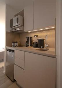 a kitchen with white cabinets and a counter top at Studio Apartment Zona 10 near airport in Estación Pamplona