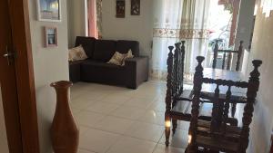 a living room with a couch and a chair at Casa Temporada Peter in Tutóia