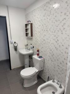 a bathroom with a toilet and a sink at Loft Neuquén in Neuquén
