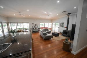 a living room with a couch and a table at Terara Riverview Estate in Terara