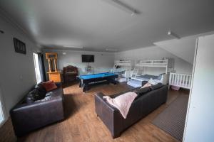a living room with a couch and a pool table at Terara Riverview Estate in Terara +86 photos
