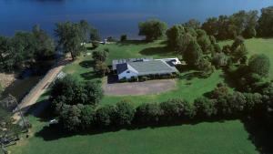an overhead view of a large house on a island in the water at Terara Riverview Estate in Terara