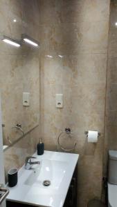 La salle de bains est pourvue d'un lavabo et d'un miroir. dans l'établissement Madrid Rent 3, à Madrid