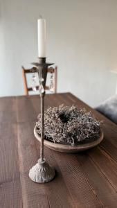 Eine Kerze steht auf einem Holztisch in der Unterkunft Schmuckes Rustico in Pianezzo