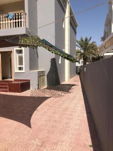 a building with a banner hanging off the side of it at Heritage Hostel Muscat in Muscat