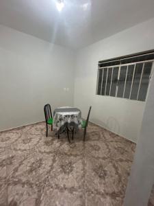 a table and two chairs in a room at Casa BIG John 4 Bahia in Divinópolis +11 photos