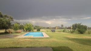 a swimming pool in the middle of a field at Alalá Campo in Pocito