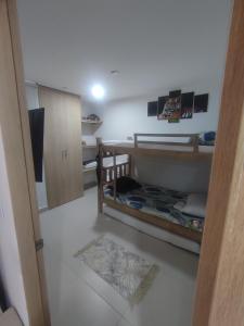 a room with a bunk bed and a room with a floor at Via Tayrona in Santa Marta