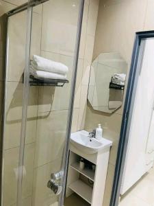 a bathroom with a sink and a shower at Rooibok Gardens in Mokopane