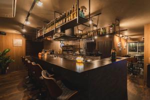 a bar in a restaurant with a long counter at Laon Inn Plus Miyakojima in Miyako-jima