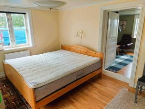 a bedroom with a wooden bed in a room at 4 star holiday home in ÖDESHÖG in Ödeshög
