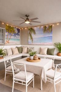 a living room with a table and chairs and a couch at The Olympic Suites LA in Los Angeles